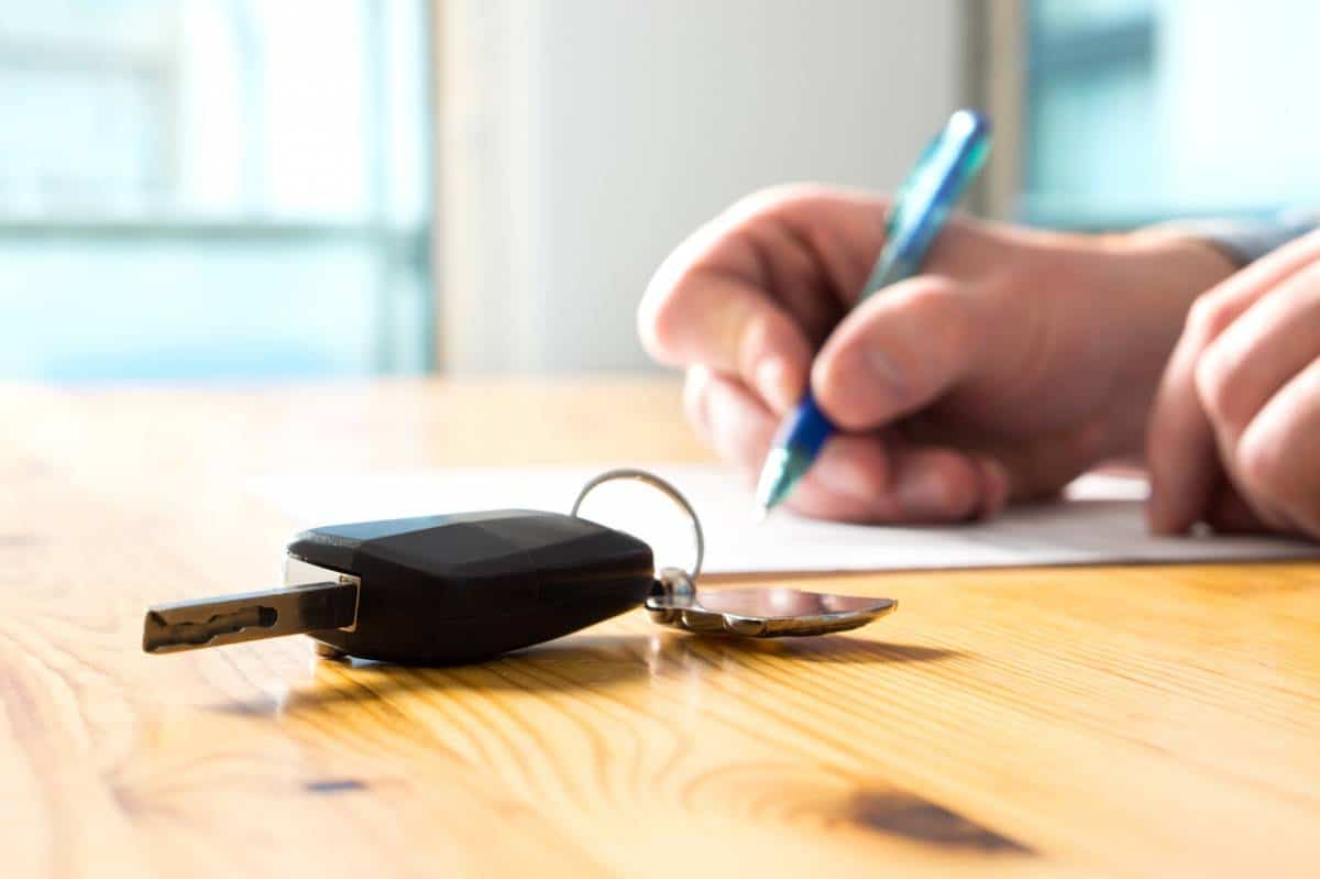 Un acheteur en train de remplir un formulaire de cession et d'achat pour son véhicule